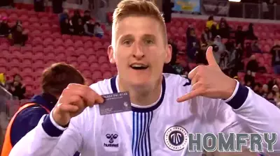 Canadian forward/real estate agent flashes business card in goal celebration